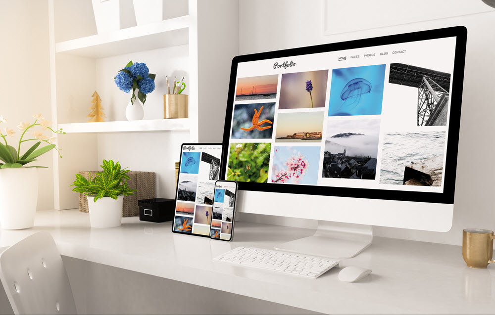 Portfolio displayed on a desktop computer and tablet on a desk