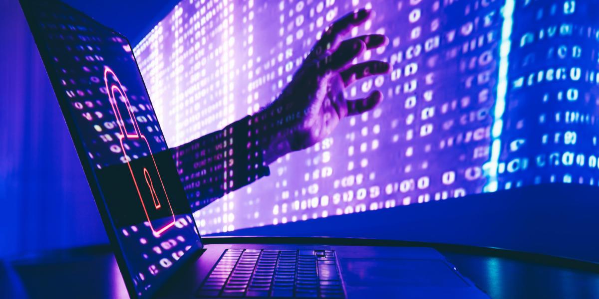 A hand reaching out of a laptop screen.